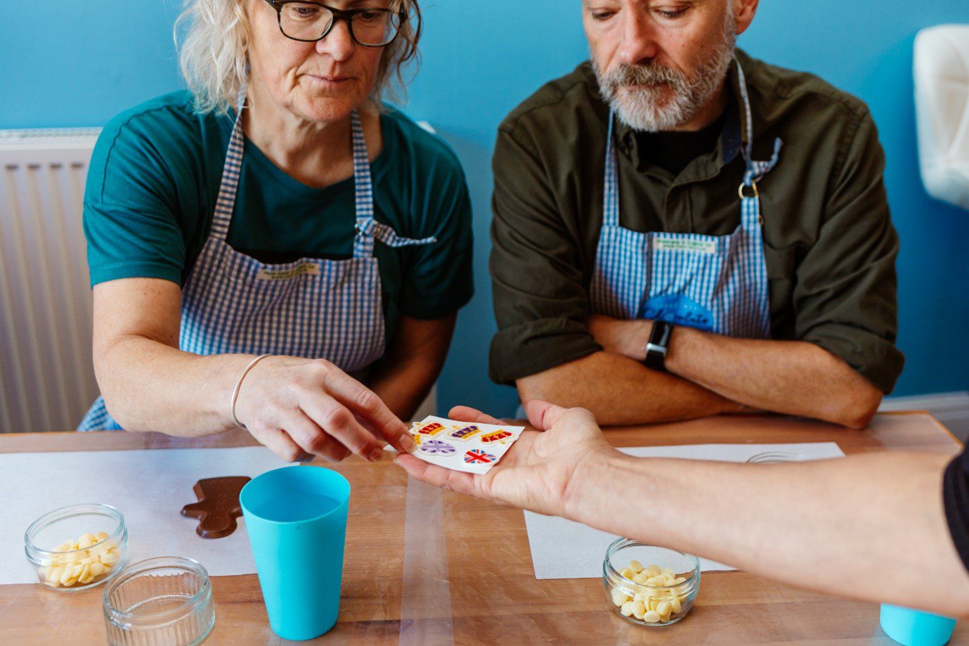 A man and a woman at a chocolate making workshop in Ilfracombe at the Chocolate Emporium