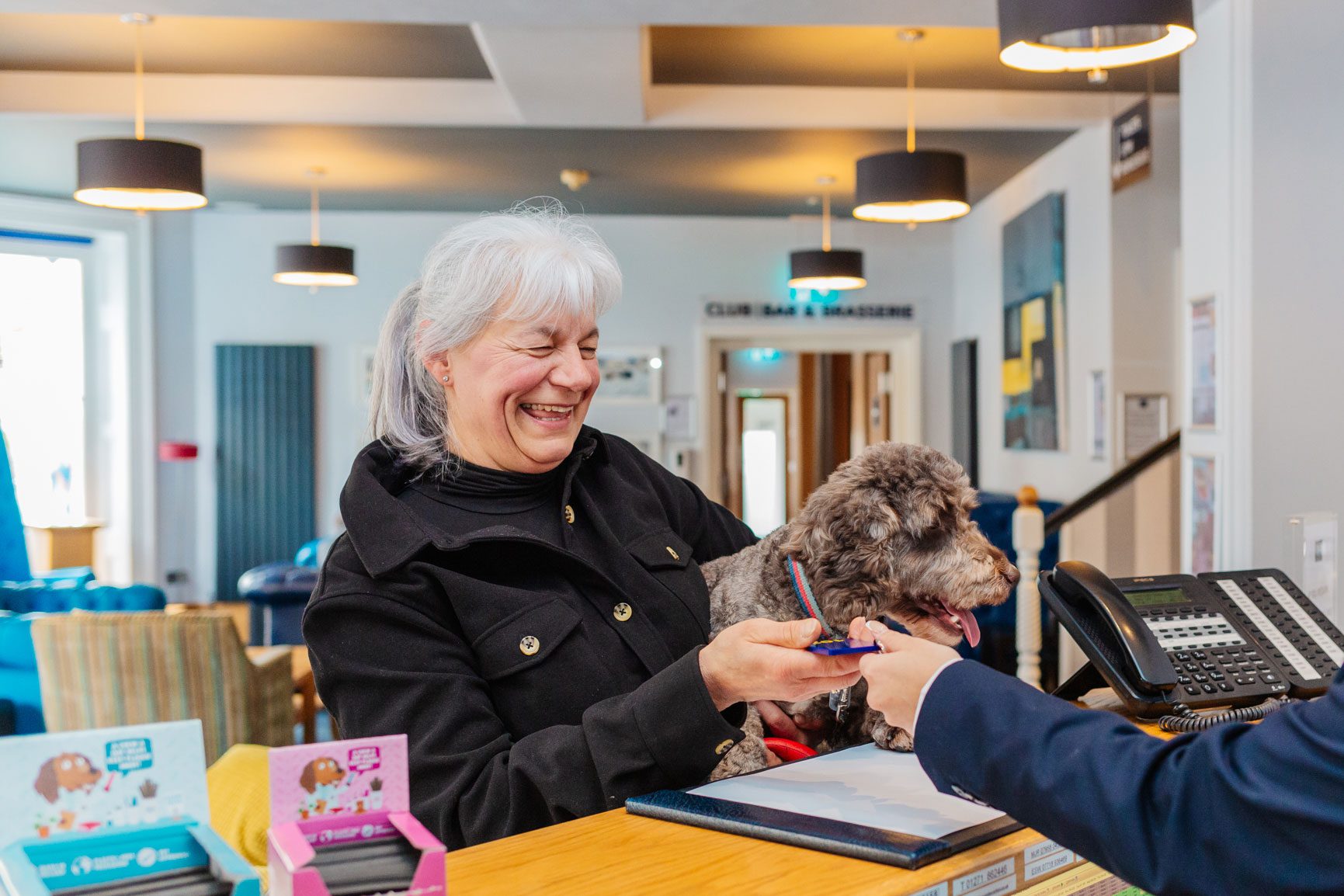 A woman and her dog checking into a dog-friendly hotel in North Devon